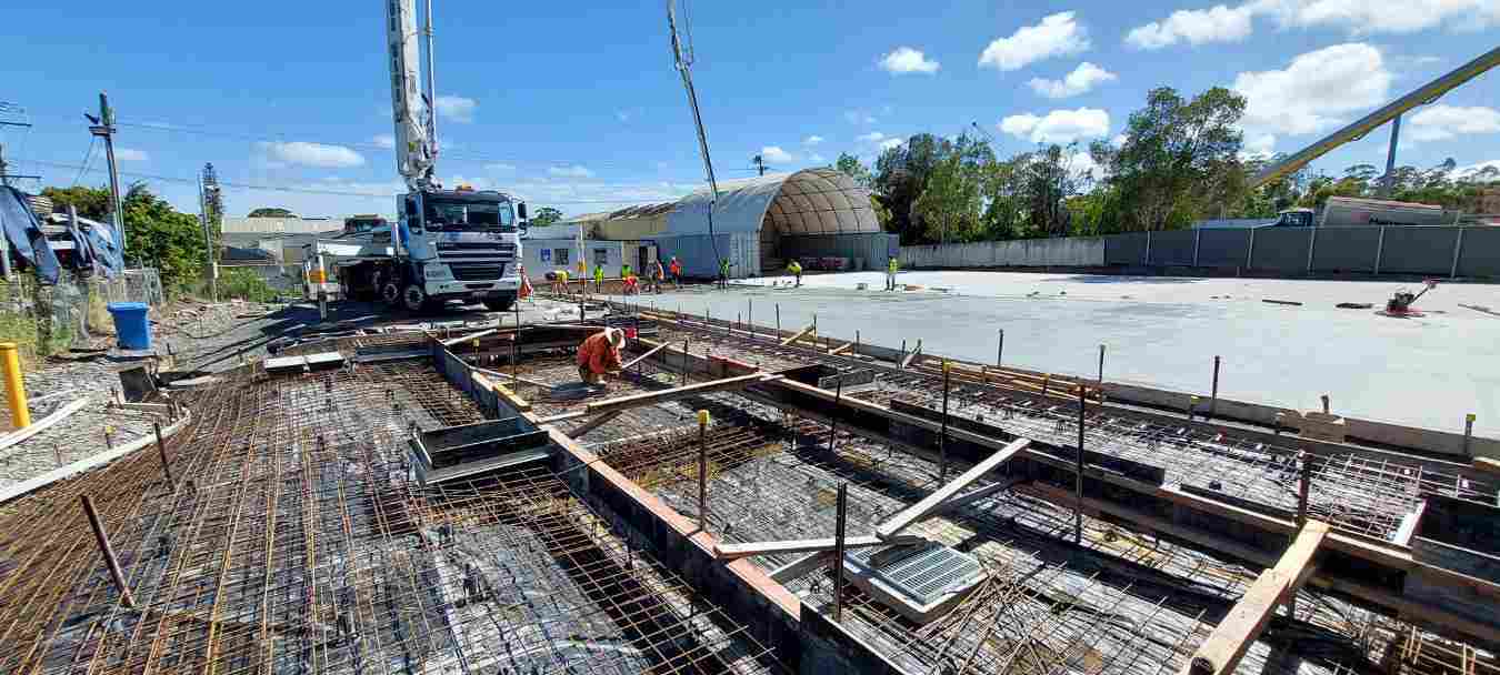 Legend-Consultants cement truck on site road being built with cement truck on site